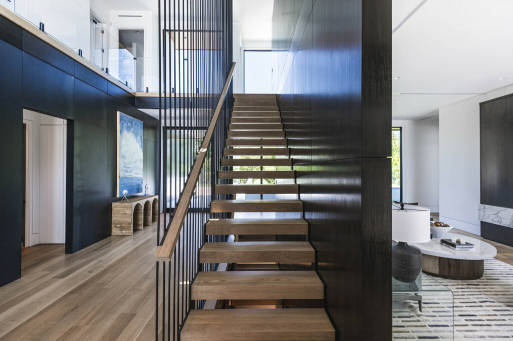 Fort pond house foyer with open concept modern wood staircase